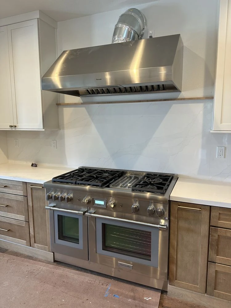 Dual-fuel professional range and stainless hood installation in Orange County