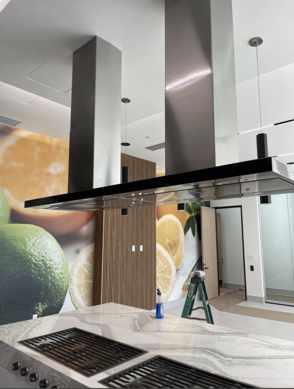 Modern island range hood and cooktop installation in Laguna Beach, CA by Peerless Group