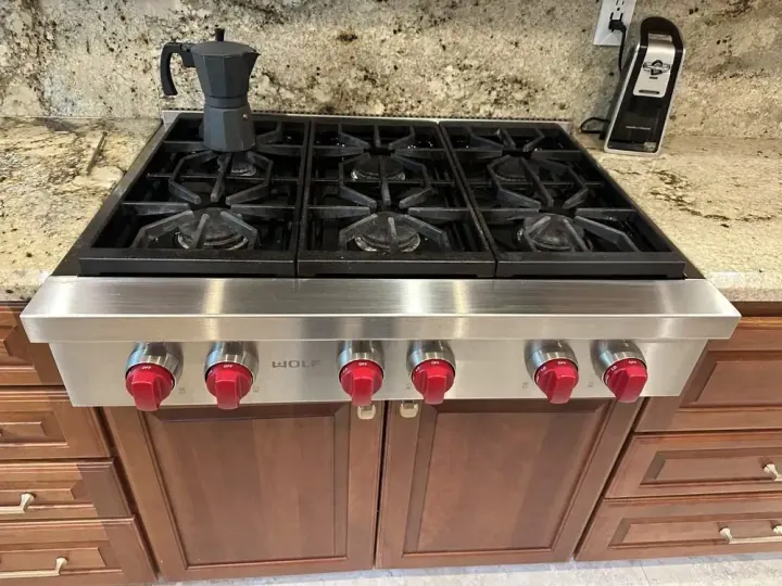 Wolf 36″ Rangetop with Red Knobs installation in Irvine by Peerless Group