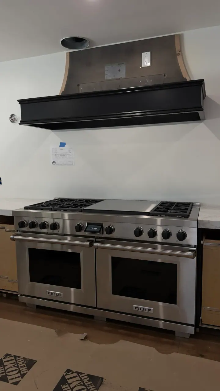 Wolf 60″ Dual Fuel Range with Black Knobs installation in Newport Beach, CA by Peerless Group