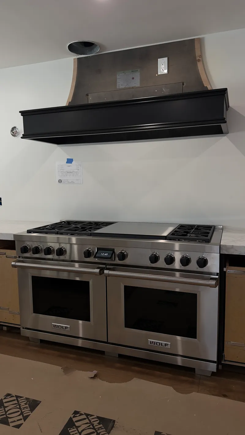 Wolf 60″ Dual Fuel Range with Black Knobs installation in Newport Beach by Peerless Group