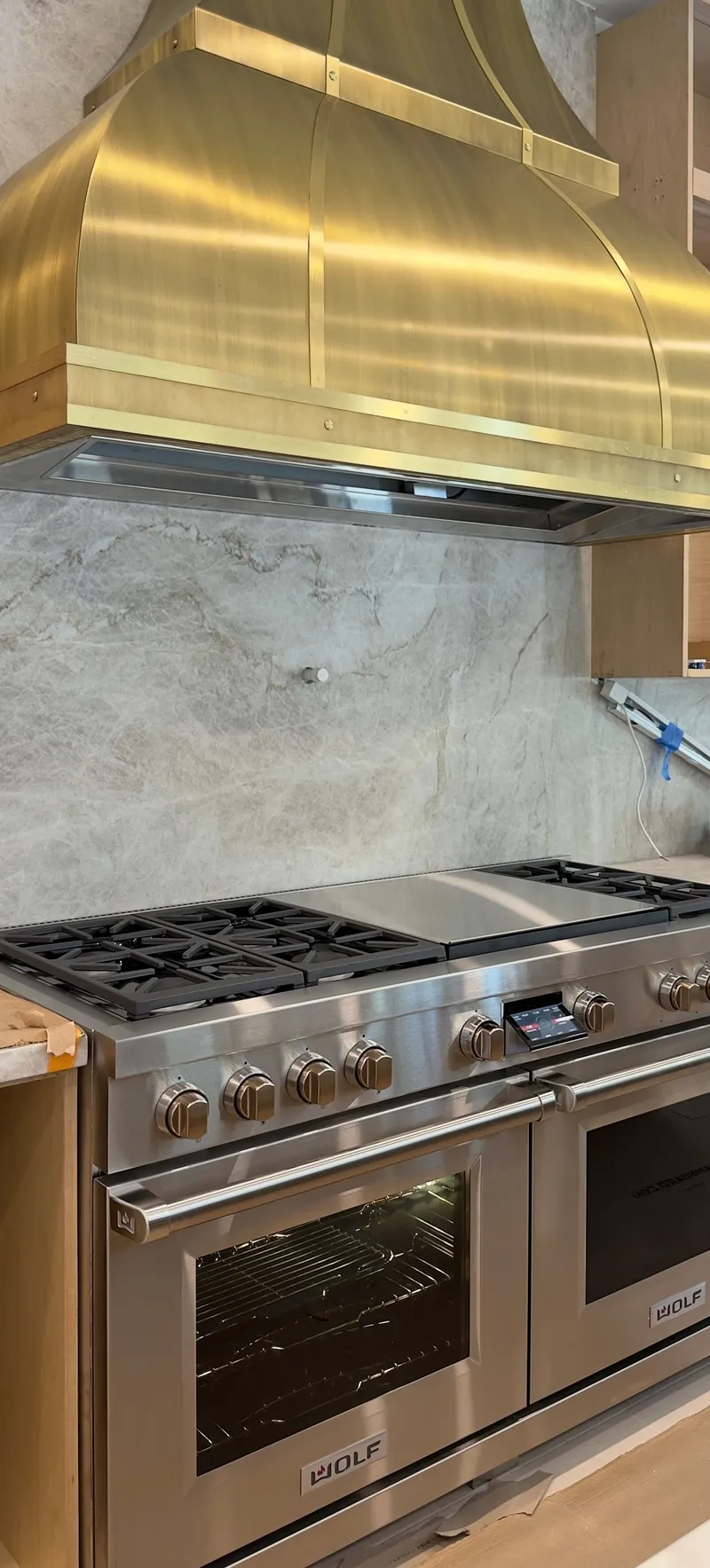 Wolf Dual Fuel Range 60″ & Custom Gold Hood installation in San Juan Capistrano by Peerless Group